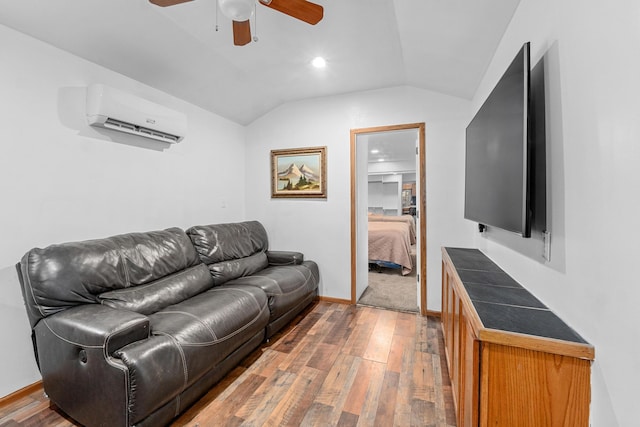 living room featuring hardwood / wood-style flooring, lofted ceiling, a wall mounted air conditioner, and ceiling fan