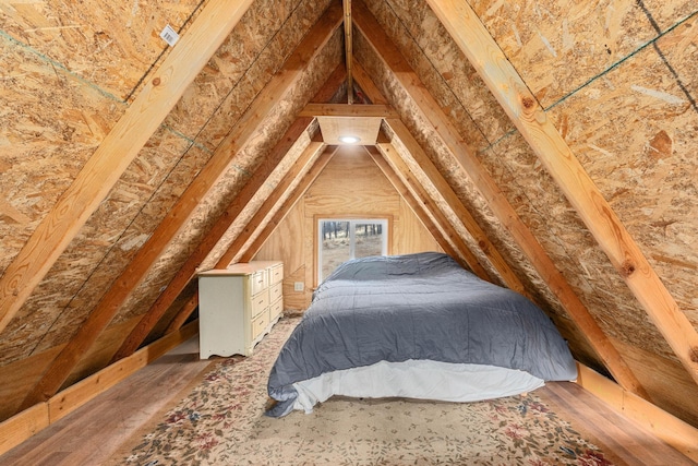 bedroom with dark wood-type flooring and vaulted ceiling