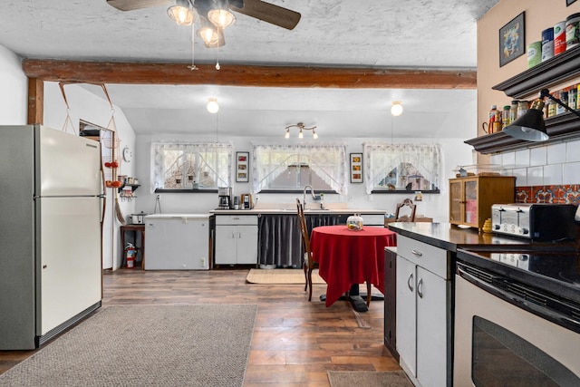 3063 Hungry Hill Rd, Kettle Falls, WA 99141 - kitchen featuring freestanding refrigerator, electric stove, ceiling fan, dark wood-style flooring, and beam ceiling
