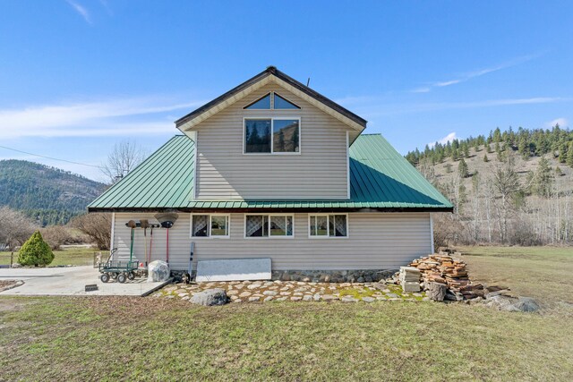 3063 Hungry Hill Rd, Kettle Falls, WA 99141 - view of home's exterior featuring metal roof, a yard, and a patio