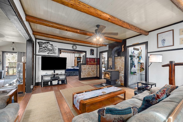 3063 Hungry Hill Rd, Kettle Falls, WA 99141 - living room featuring a wood stove, hardwood / wood-style floors, ceiling fan, beamed ceiling, and wooden ceiling
