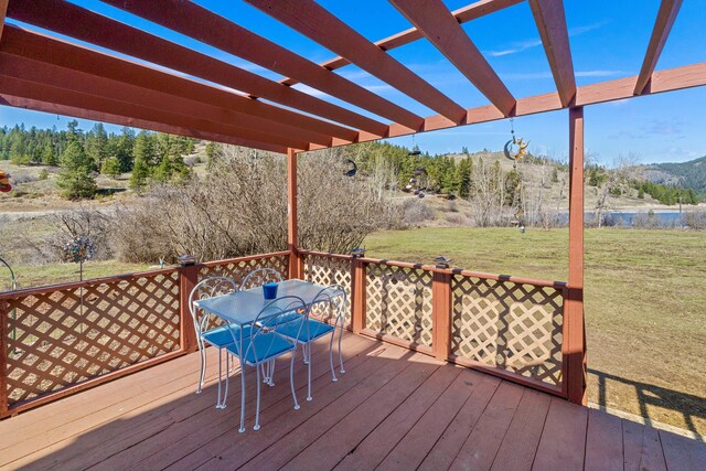 3063 Hungry Hill Rd, Kettle Falls, WA 99141 - deck featuring outdoor dining space, a pergola, a yard, and a mountain view