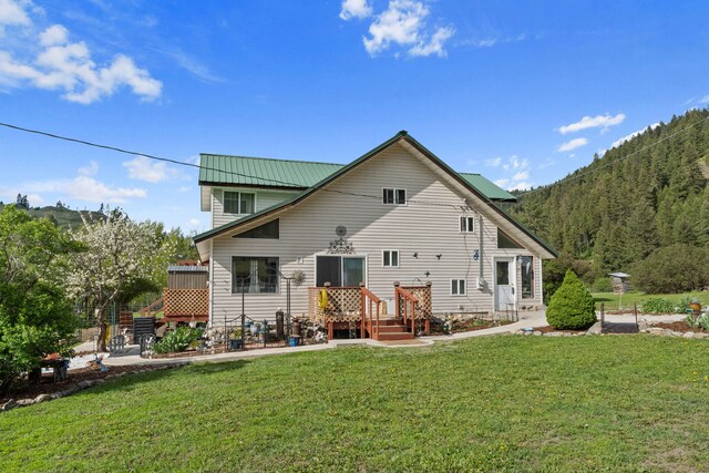 3063 Hungry Hill Rd, Kettle Falls, WA 99141 - back of property with a yard and metal roof