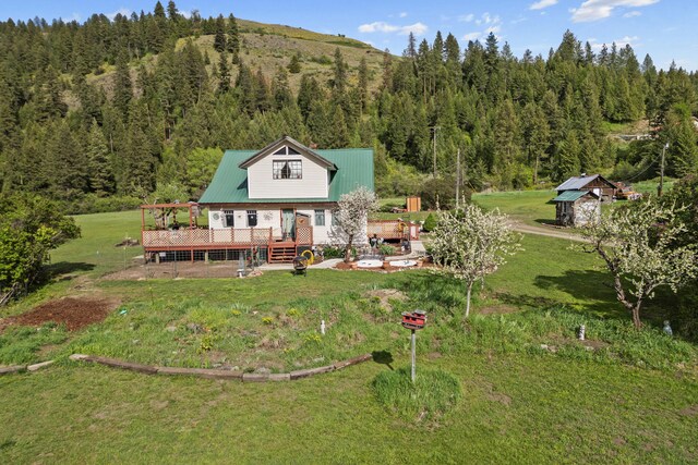 3063 Hungry Hill Rd, Kettle Falls, WA 99141 - back of property featuring a forest view, a wooden deck, and a yard