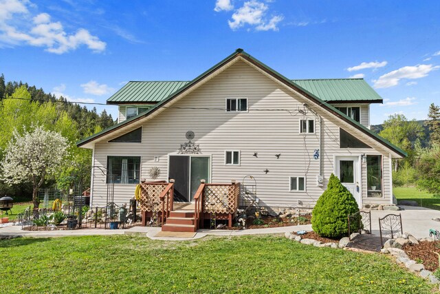 3063 Hungry Hill Rd, Kettle Falls, WA 99141 - rear view of property featuring a yard, a deck, and metal roof