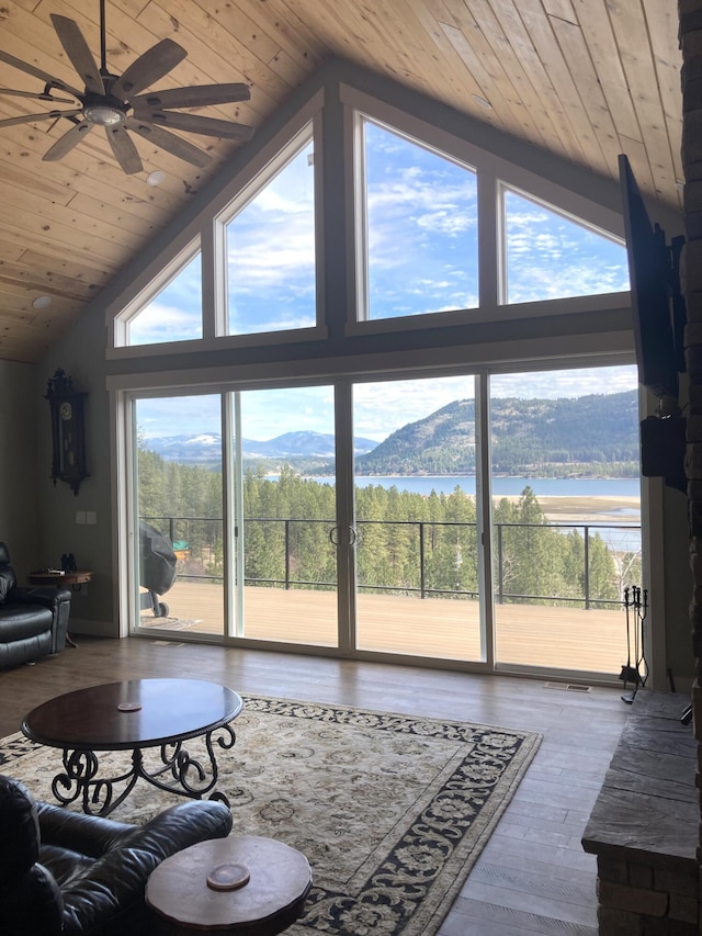 living area featuring wood ceiling, high vaulted ceiling, a ceiling fan, and wood finished floors