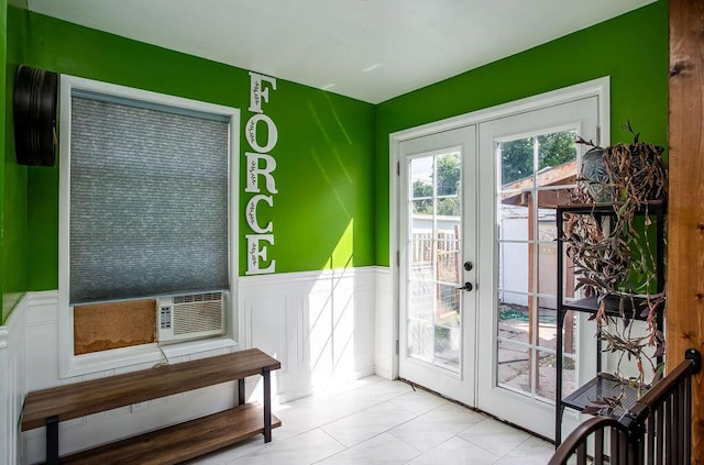 doorway featuring light tile patterned flooring and french doors