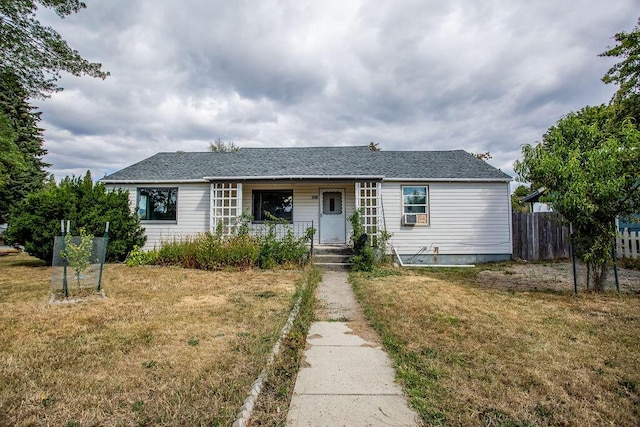 ranch-style house with a porch and a front lawn