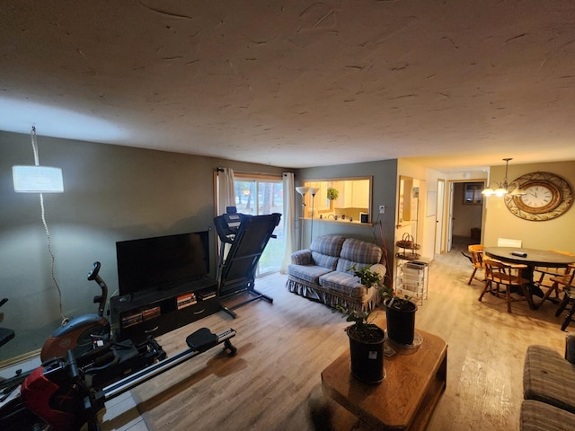 living room featuring hardwood / wood-style flooring and an inviting chandelier