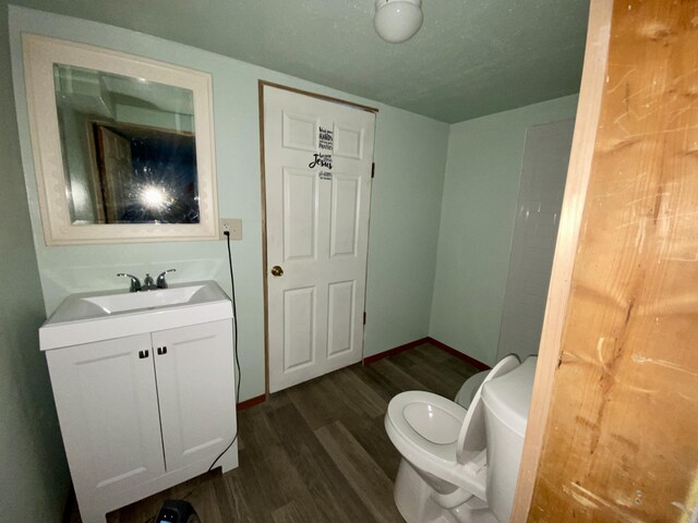 530 Kalmia St, Kettle Falls, WA 99141 - bathroom with toilet, vanity, and hardwood / wood-style floors