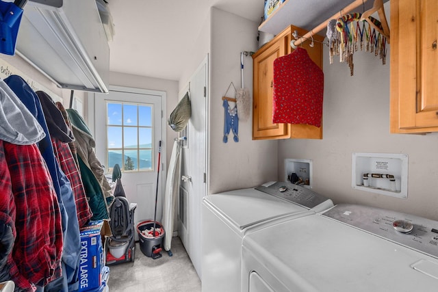 washroom featuring cabinet space and independent washer and dryer