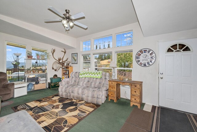 living area featuring ceiling fan and carpet