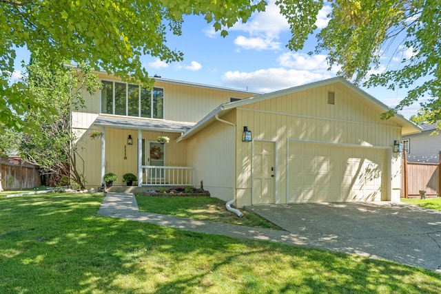 view of front of house with a garage, a front lawn, and covered porch