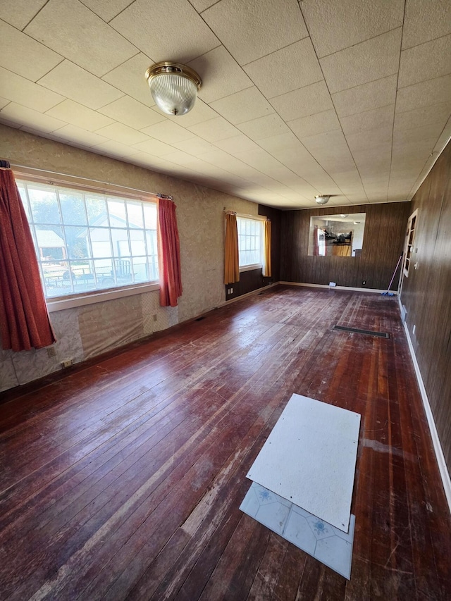707 N 4th St W, Chewelah, WA 99109 - unfurnished room with hardwood / wood-style flooring and wooden walls