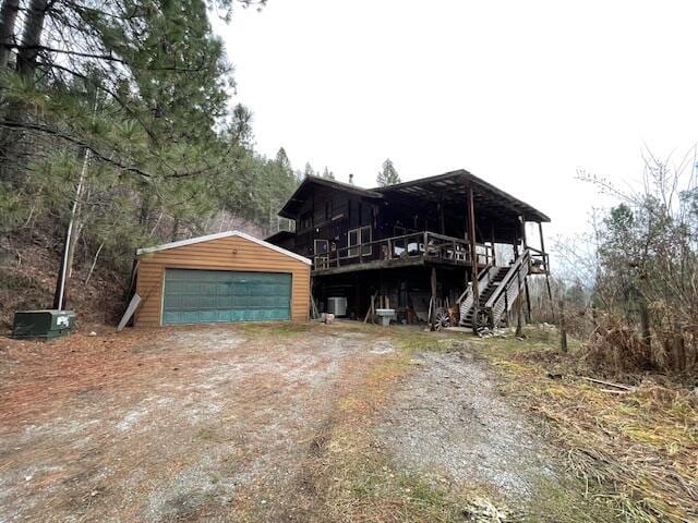 view of front of property featuring a garage and an outbuilding