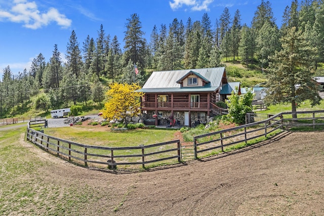 1427 Chapin Rd N, Evans, WA 99126 - cabin with log exterior, metal roof, dirt driveway, and a forest view