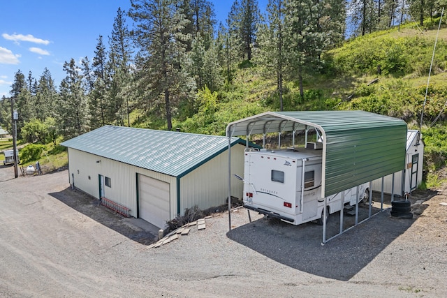 1427 Chapin Rd N, Evans, WA 99126 - detached garage featuring gravel driveway and a carport