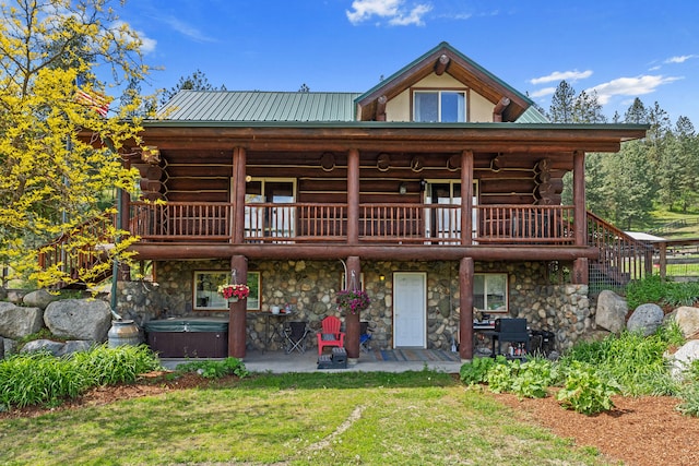 1427 Chapin Rd N, Evans, WA 99126 - back of house with a hot tub, a patio area, log siding, and stone siding