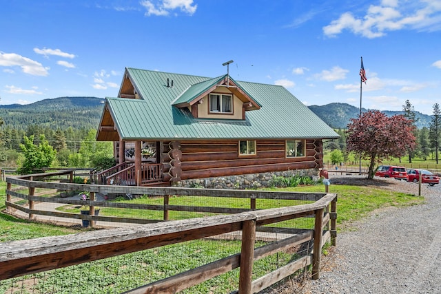 1427 Chapin Rd N, Evans, WA 99126 - view of property exterior with log siding, a mountain view, and metal roof