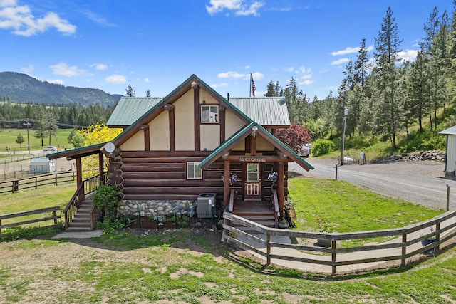 1427 Chapin Rd N, Evans, WA 99126 - log-style house with log exterior, metal roof, central AC unit, and a mountain view