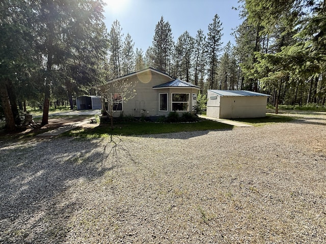 1874 Brooks Rd, Evans, WA 99126 - view of front facade featuring an outdoor structure and a metal roof
