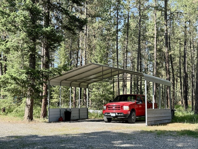 1874 Brooks Rd, Evans, WA 99126 - view of parking / parking lot with a carport, a wooded view, and gravel driveway