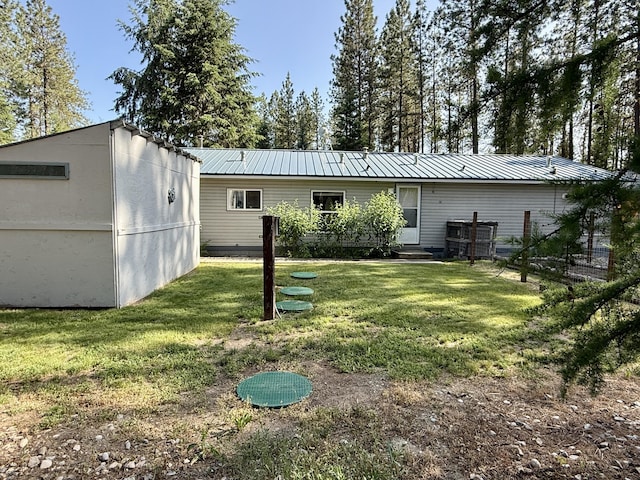 1874 Brooks Rd, Evans, WA 99126 - rear view of property with a lawn and a metal roof