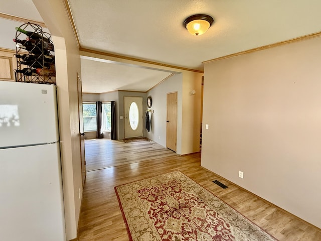 1874 Brooks Rd, Evans, WA 99126 - entryway with ornamental molding, light wood-style floors, lofted ceiling, and a textured ceiling
