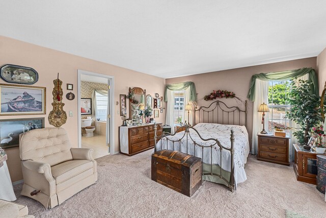 76 Kifer Rd, Kettle Falls, WA 99141 - bedroom with light carpet, multiple windows, and ensuite bathroom