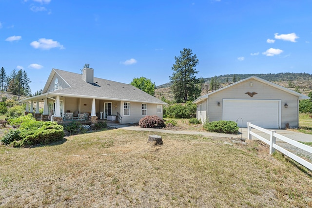 76 Kifer Rd, Kettle Falls, WA 99141 - rear view of house featuring a porch, a garage, a chimney, and an outdoor structure