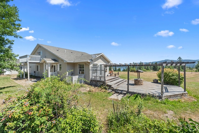 76 Kifer Rd, Kettle Falls, WA 99141 - back of house with a pergola, a wooden deck, a yard, and roof with shingles