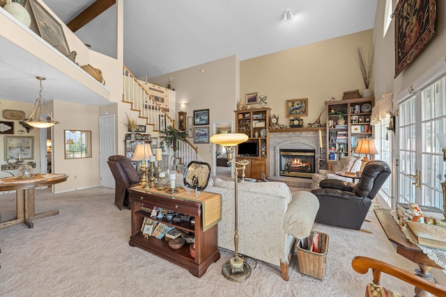 76 Kifer Rd, Kettle Falls, WA 99141 - carpeted living area with high vaulted ceiling, a brick fireplace, and stairs