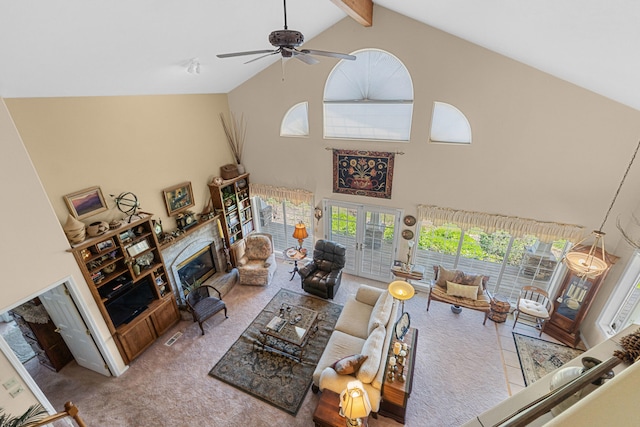 76 Kifer Rd, Kettle Falls, WA 99141 - living room featuring high vaulted ceiling, a glass covered fireplace, beam ceiling, carpet floors, and ceiling fan
