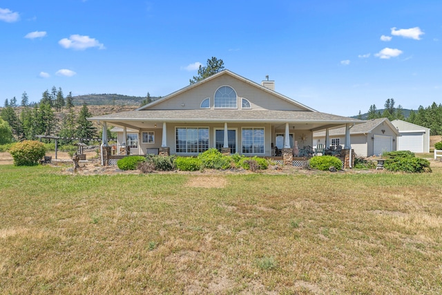 76 Kifer Rd, Kettle Falls, WA 99141 - view of front of home featuring covered porch, a chimney, and a front lawn