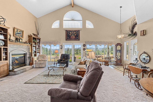 76 Kifer Rd, Kettle Falls, WA 99141 - living area featuring carpet floors, high vaulted ceiling, a tile fireplace, and beamed ceiling