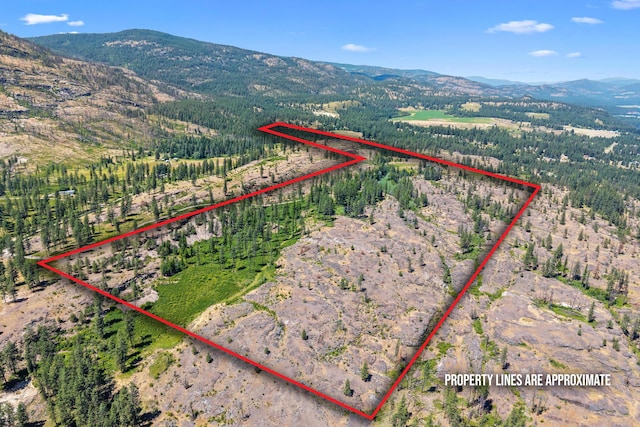 76 Kifer Rd, Kettle Falls, WA 99141 - aerial view of property's location with mountains, property parcel outlined, and rural landscape