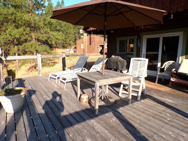 wooden terrace featuring an outbuilding