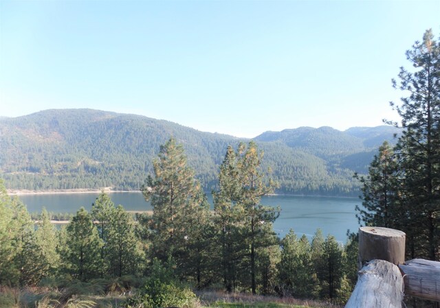 wooden terrace with a water and mountain view