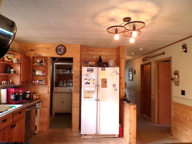 kitchen with dishwasher, light wood-type flooring, brown cabinets, white refrigerator with ice dispenser, and open shelves