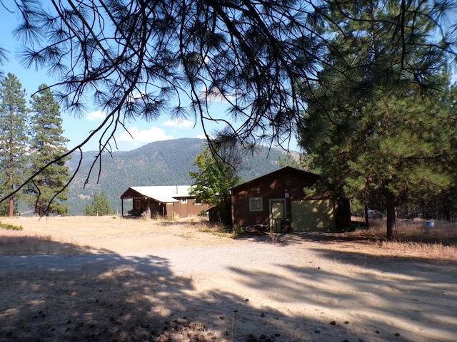 view of side of home with a mountain view