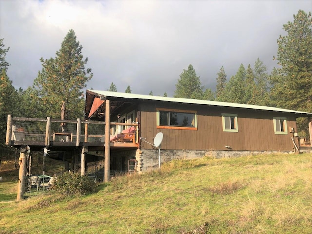 back of property featuring a wooden deck