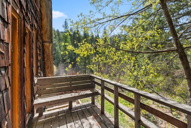 wooden deck with a view of trees