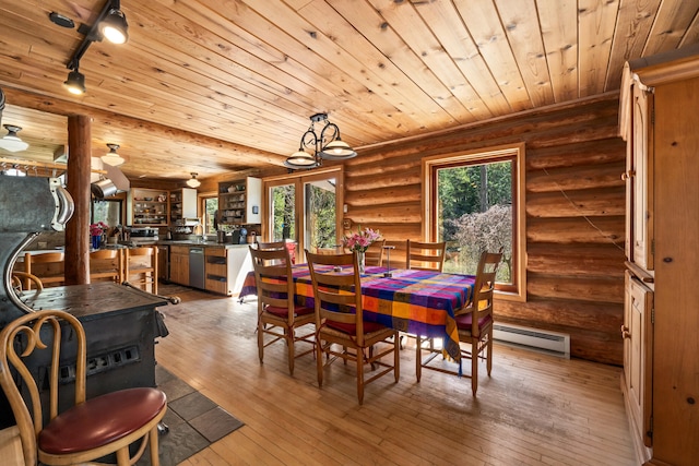 dining room with rail lighting, wood ceiling, rustic walls, and hardwood / wood-style floors