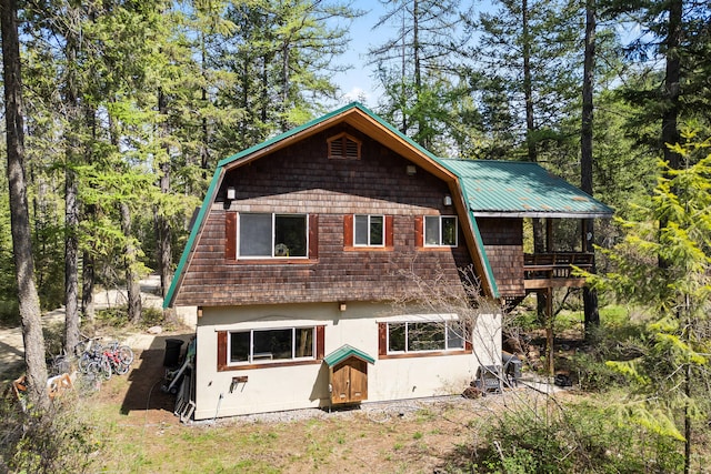 back of property featuring stucco siding