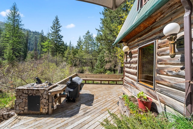 wooden deck featuring a view of trees