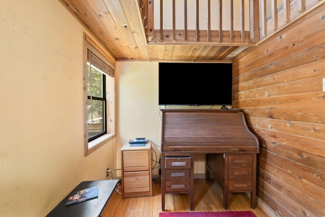 home office with wood walls, wooden ceiling, and light wood-style flooring
