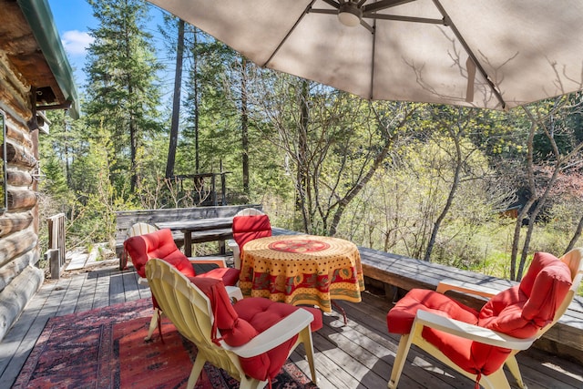 wooden terrace with outdoor dining space