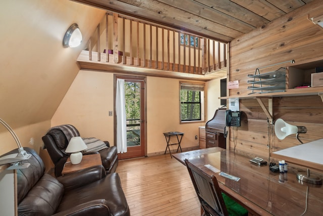 office with baseboards, lofted ceiling, and hardwood / wood-style floors