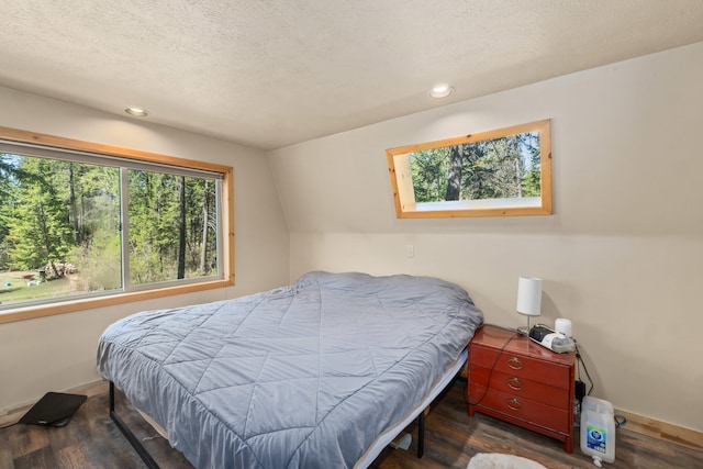 bedroom featuring recessed lighting, a textured ceiling, baseboards, and wood finished floors