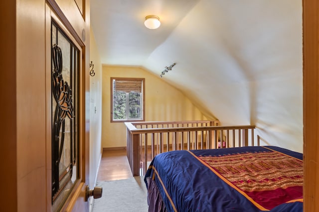 bedroom with baseboards, carpet floors, and lofted ceiling
